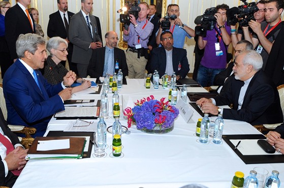 U.S. Secretary of State John Kerry and Iranian Foreign Minister Mohammad Javad Zarif in Vienna, Austria, on July 14, 2014, sitting for a bilateral meeting focused on Iran's nuclear program. [State Department photo/ Public Domain]